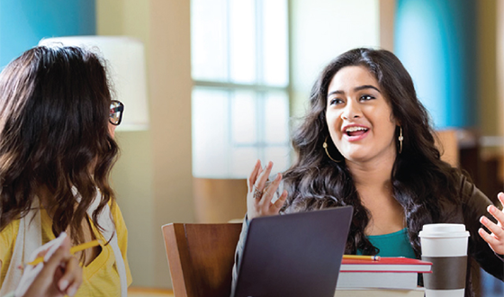 Two female educators conversing