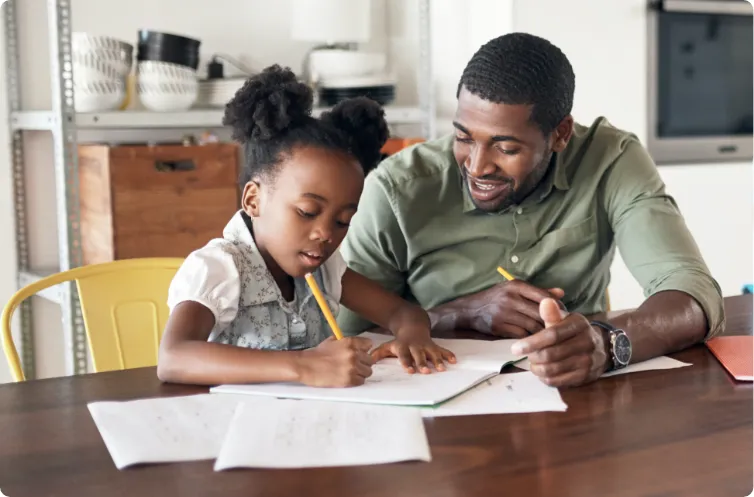 father with daughter helping her with homework