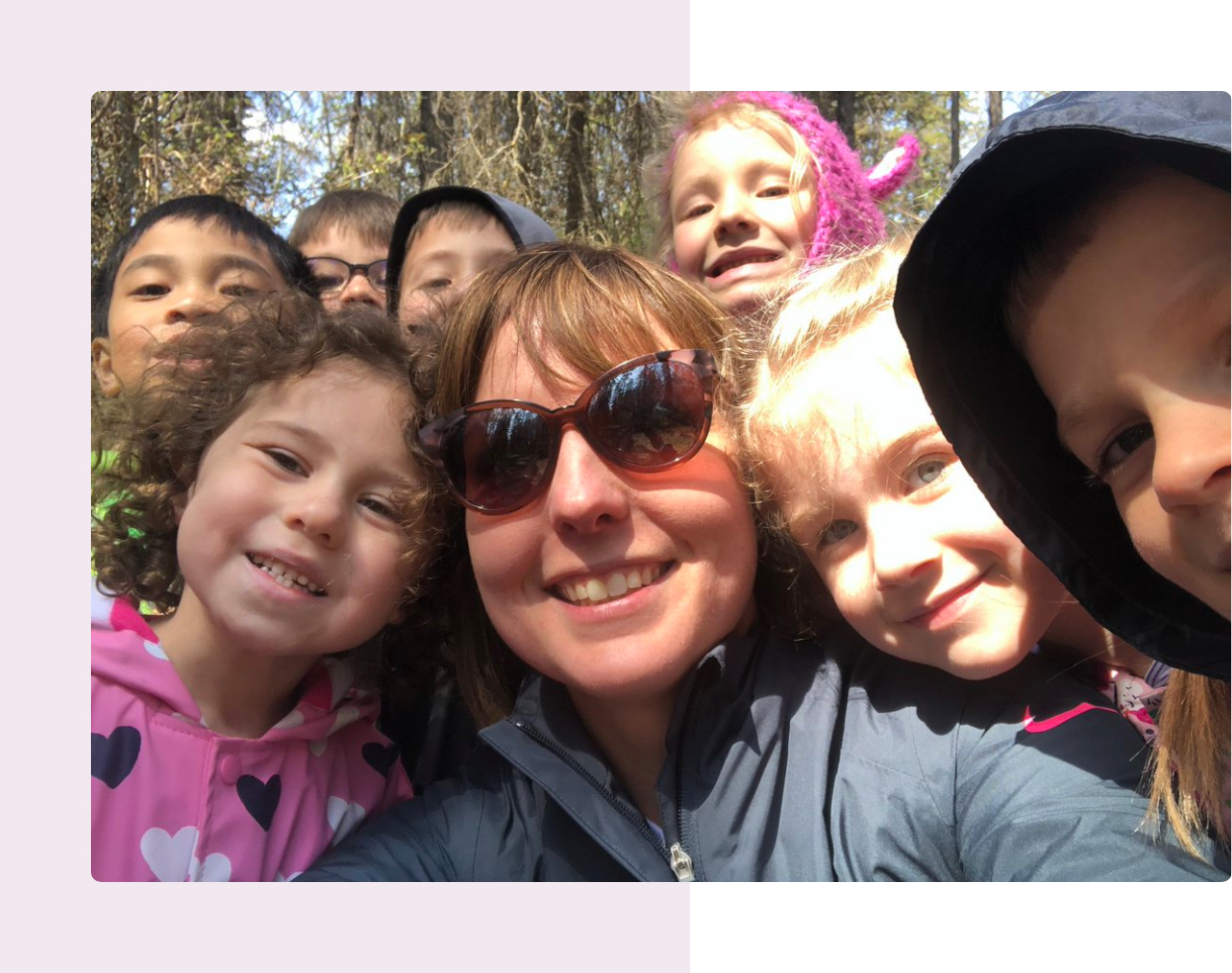 teacher with children outdoors taking a selfie looking happy