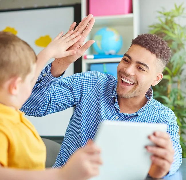 teacher giving a high five to a child