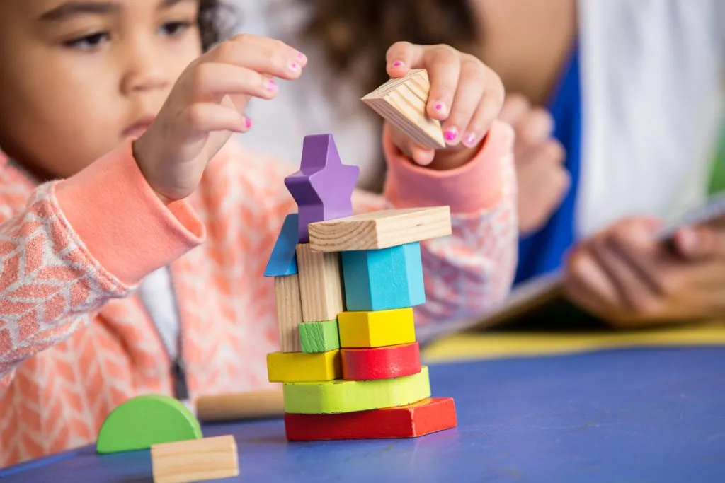 focused child using blocks in preschool