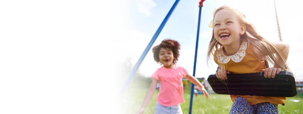 two children enjoying the swings