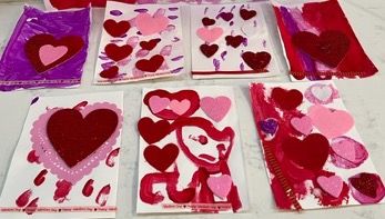 A sampling of 7 Valentine's Day crafts, of hearts on white paper, all looking different and unique!