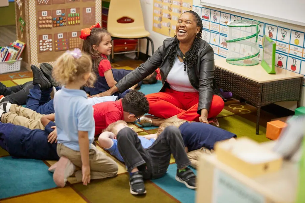 Teacher laughing with her students.