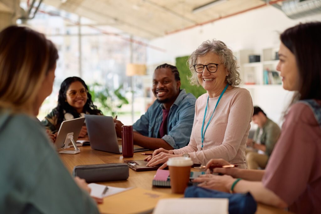 Five teachers talking around a table